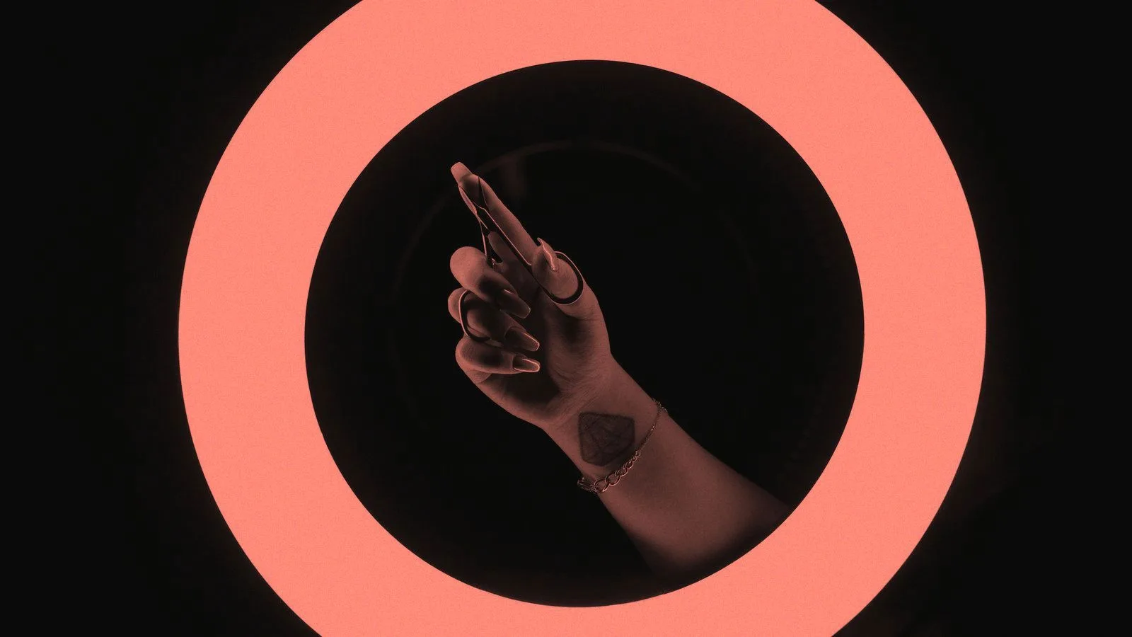 A hand holding a phone framed inside a lit ring light