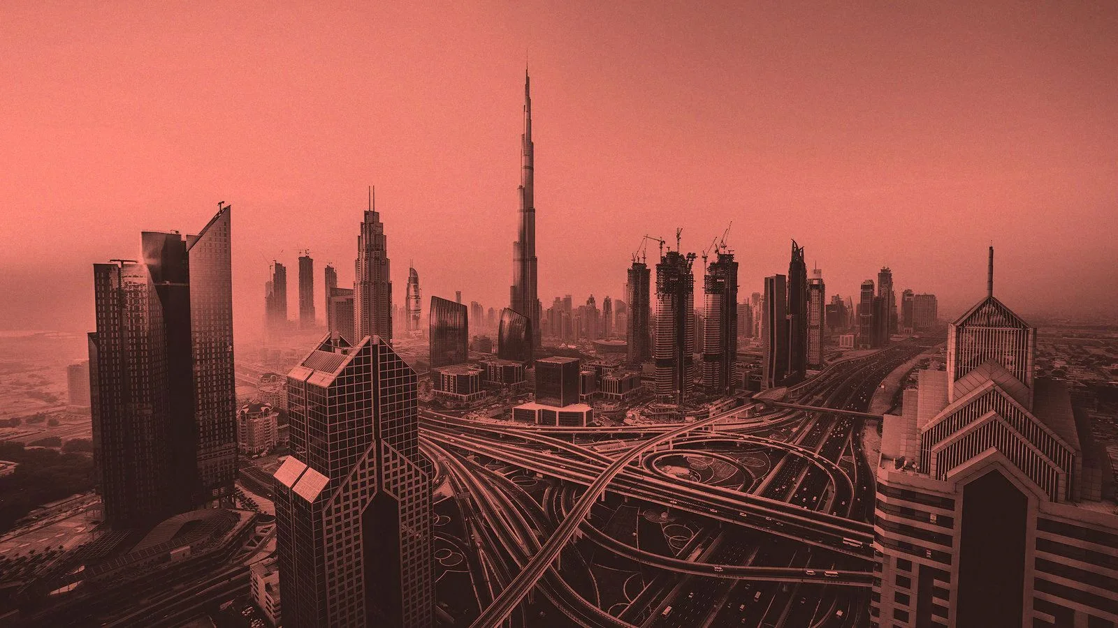 Aerial view of the Dubai skyline and Sheikh Zayed Road at dawn